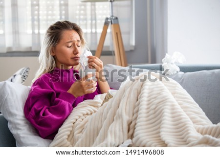 Cold And Flu. Portrait Of Woman Caught Cold, Feeling Sick And Sneezing In Paper Wipe. Closeup Of Beautiful Unhealthy Girl Covered In Blanket Wiping Nose. Healthcare Concept. High Resolution