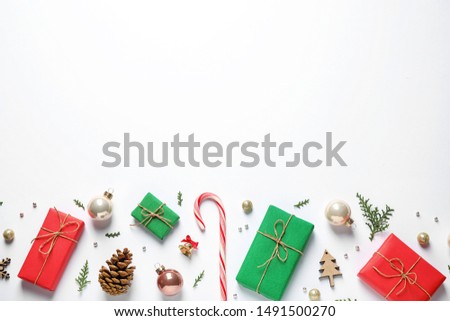 Flat lay composition with Christmas gifts and festive decor on white background. Space for text