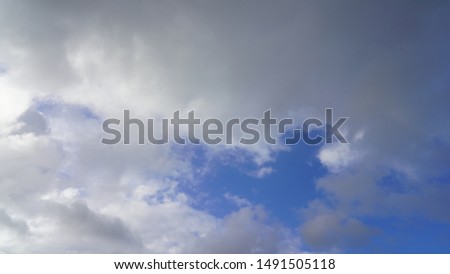 
White curly clouds on a background of clear blue sky background picture