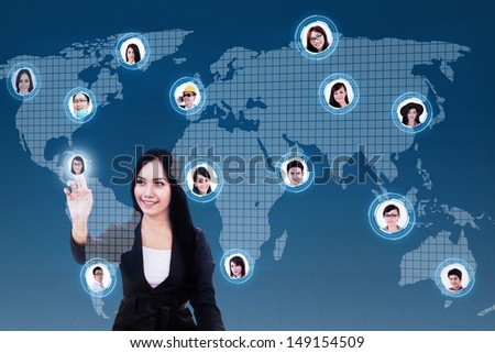 Asian business woman with social networking lcd screen against world map background