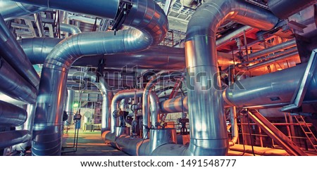 Equipment, cables and piping as found inside of a modern industrial power plant                        Royalty-Free Stock Photo #1491548777