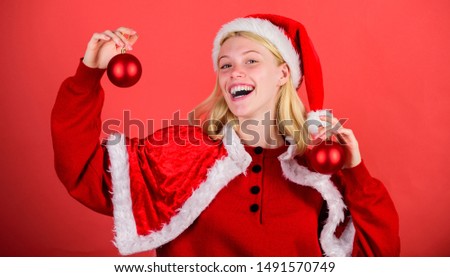 Girl happy wear santa costume celebrate christmas hold ball decor red background. Christmas preparation concept. Favorite time year christmas. Christmas fun. Enjoy celebration with costume and decor.