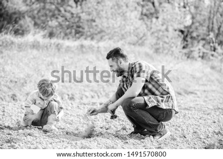 Eco living. happy earth day. Family tree. father and son planting flowers in ground. new life. soils fertilizers. rich natural soil. Eco farm. small boy help father in farming. earth day. earth day.