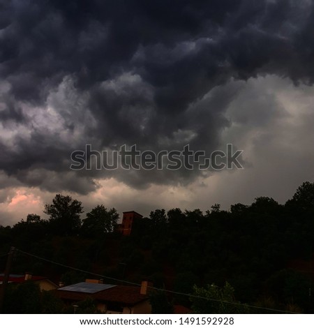  dark and gloomy landscape with trees and sky with gray clouds