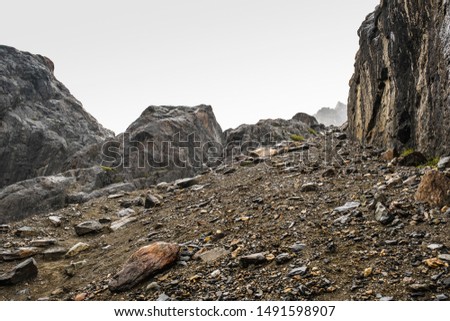 A sloping slope covered with loose stones. Difficult climb to Aktru. Beautiful views of the rounded mountains on a tour of the nature of Altai land. Hiking and mountain climbing in the mountains. Royalty-Free Stock Photo #1491598907