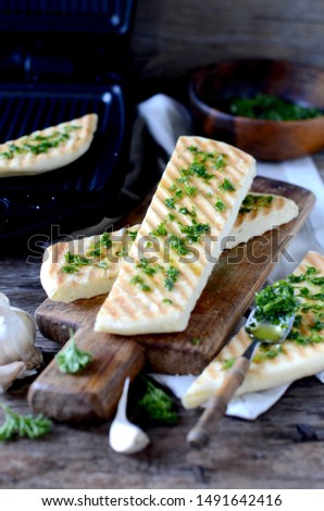 Grilled tortilla with greens sauce on a wooden table