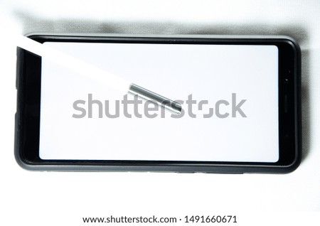 Electronic signature by a man hand on a smartphone with a black frame on a white background: close, top, side