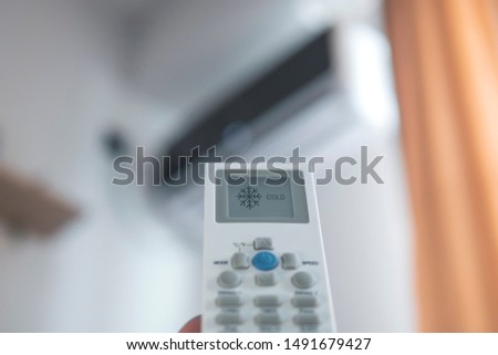 Remote control on cooling mode directed at the air conditioner at home/office