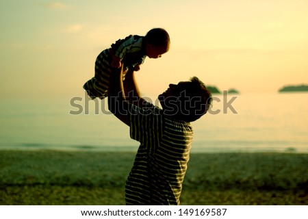 silhouette family of child hold on father hand