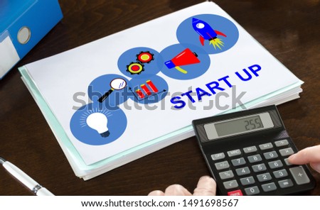 Start up concept illustrated on a paper with a calculator