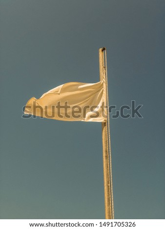 White flag with clear sky