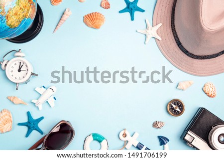 Frame of vacation accessories on a blue background. Flat lay travel concept . World tourism day