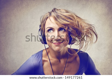 beautiful woman with tousled hair listening the music