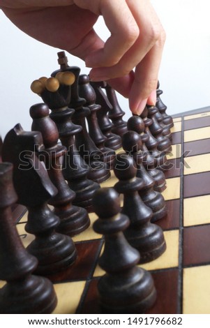 Hand and chessboard, isolated on white background