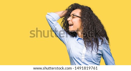 Young beautiful business girl with curly hair wearing glasses Dancing happy and cheerful, smiling moving casual and confident listening to music