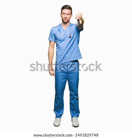 Handsome doctor man wearing medical uniform over isolated background looking unhappy and angry showing rejection and negative with thumbs down gesture. Bad expression.