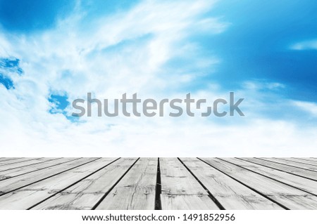 Wooden terrace over the blue sky