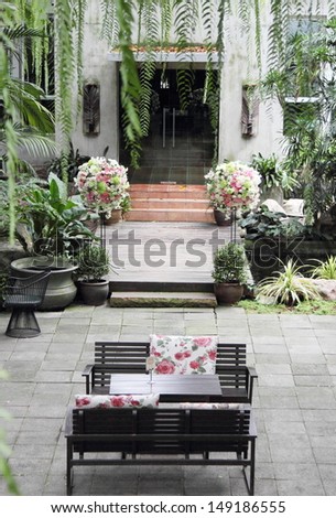 Table and chairs in a tropical garden
