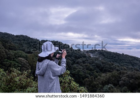 Girls touring and taking pictures of rain forests in northern Thailand