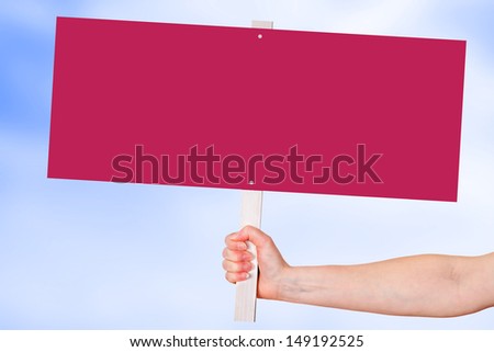 Hand holding blank red sign