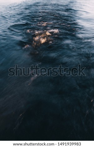 art picture of water, landscape, sunset.Trail and pattern on the water from the boat. Water skiing,kiting
