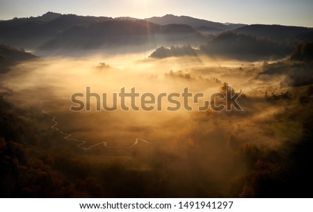 mountain landscape with autumn morning fog at sunrise - Fundatura Ponorului, Romania
