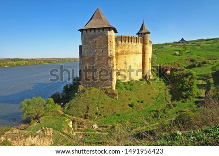 Mighty medieval fortress in town of Khotyn (Western Ukraine, Chernivtsi region) on bank of Dnister river, nowadays museum and popular travel destination. Huge high castle tower with sky on background. Royalty-Free Stock Photo #1491956423