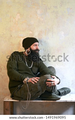 bearded fashionable men sitting on a room