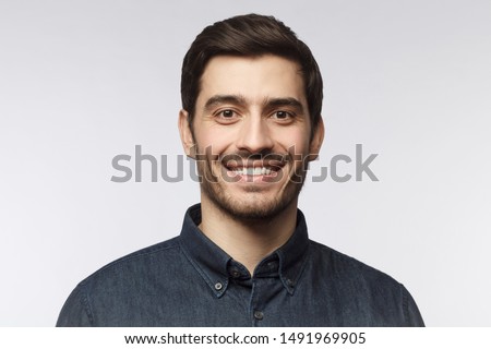 Headshot of smiling handsome man with trendy haircut isolated on gray background Royalty-Free Stock Photo #1491969905