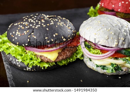 burgers in colorful buns. assortment of meat burgers with vegetables
