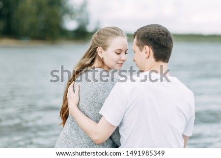  a walk in the woods by the pier. young couple walking on the lake.
