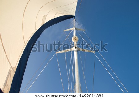 Catamaran mast and the blue sky. Royalty-Free Stock Photo #1492011881