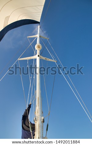 Catamaran mast and the blue sky. Royalty-Free Stock Photo #1492011884