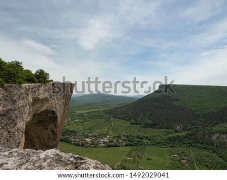 view of the green valley with trees and meadows, on a sunny day with some clouds. View of the mountain. Spring view of the Crimean mountains.