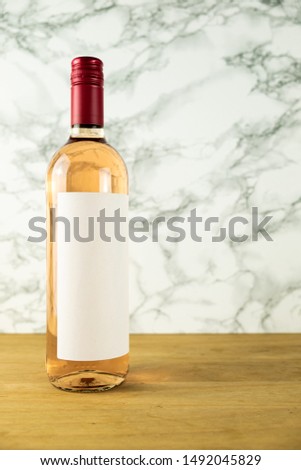bottle of wine with blank label on marble background