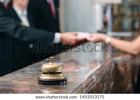 Picture of guests getting key card in hotel 