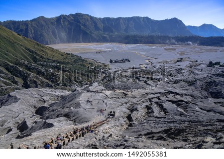 View from the top of Mount Bromo on stairs leading to the crater of this active volcano and people ascending on it, Bromo Tengger Semeru Park