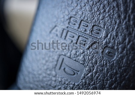 Close up image of the airbag and horn signs on the steering wheel of a car Royalty-Free Stock Photo #1492056974