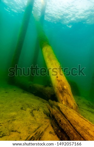 Remains of a wooden pier Munising Bay  in Lake Superior laying at an angle. Royalty-Free Stock Photo #1492057166