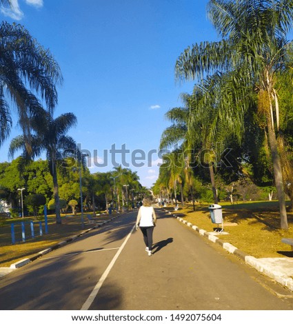 A woman walking in the urban park.