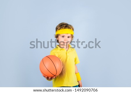 Basketball player in sportswear. Sport active. Hobby sport concept. Kid holds basketball. Sporty boy with ball. Sport, fitness, healthy lifestyle. Sport for children. Kid playing with basketball.