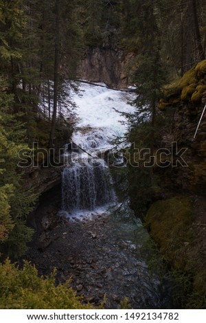 waterfall in banff canada with very blue waters from glaciers