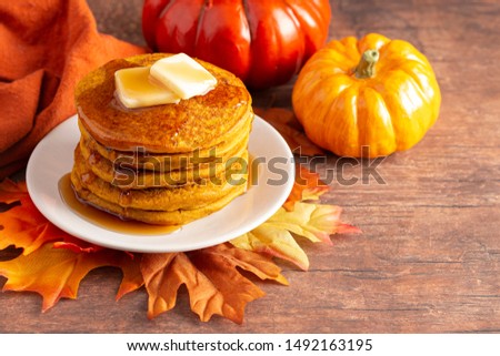 A Stack of Pumpkin Spice Flavored Pancakes on a Wooden Table