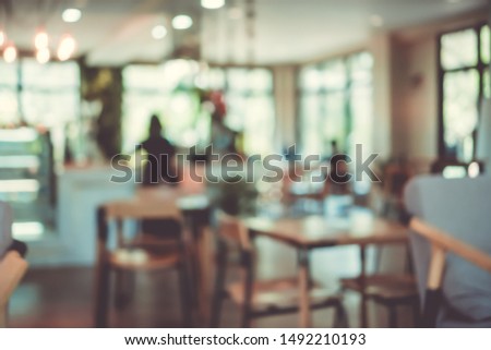 Blur coffee and restutant cafe with customers background vintage tone color style.