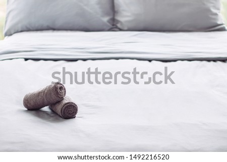grey clean perfect bed, ready for guests, hotel room, towel, linens, background
