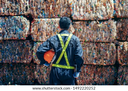 Engineer Standing and looking back The plastic bottle in the recycling industry Royalty-Free Stock Photo #1492220252