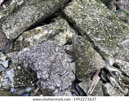Stone and concrete rubble. Remains of the destroyed industrial building.
Photo background stones rubble and wall. The texture of the stones is gray and white.