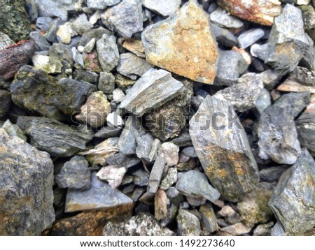 Stone and concrete rubble. Remains of the destroyed industrial building.
Photo background stones rubble and wall. The texture of the stones is gray and white.