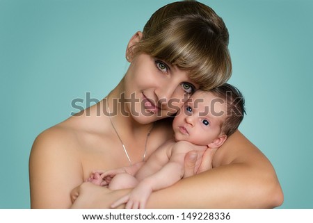 Beautiful young mother with the newborn 