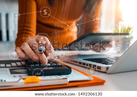 Hand man doing finances and calculate on desk about cost at home office. Royalty-Free Stock Photo #1492306130